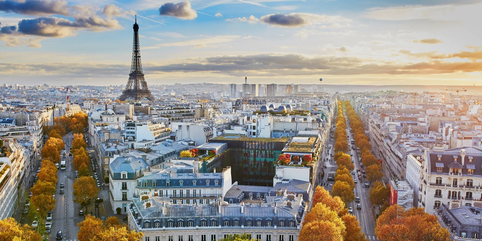 Aerial view of Paris in autumn with the Eiffel Tower and tree-lined boulevards, representing VDB Groupe's global institutional real estate footprint.